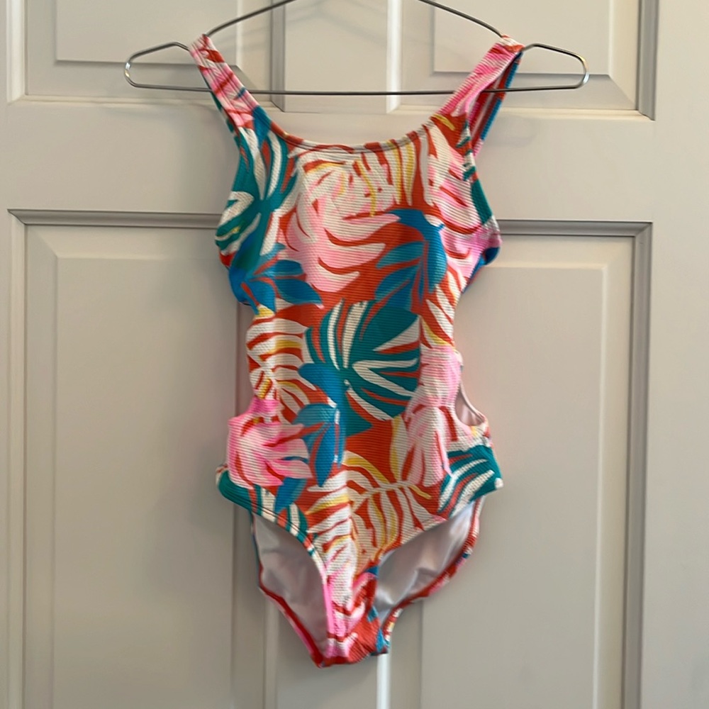 One piece swimsuit with side cut outs. Excellent condition. Size Large (10-12).